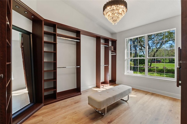 interior space featuring lofted ceiling, light hardwood / wood-style floors, and a notable chandelier