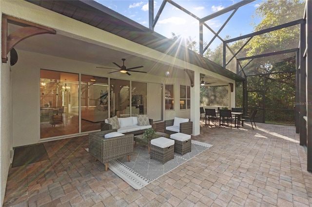 view of patio featuring ceiling fan, glass enclosure, and an outdoor living space