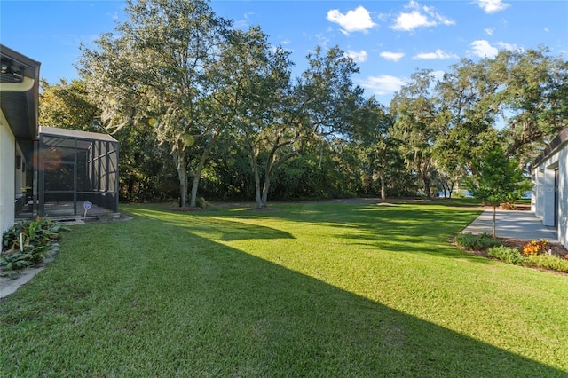 view of yard featuring glass enclosure