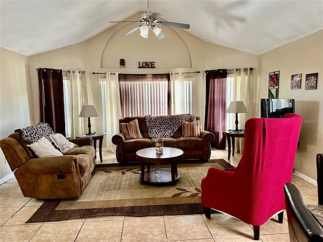 living room featuring vaulted ceiling, ceiling fan, and light tile patterned floors