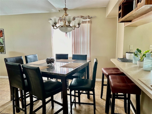 tiled dining room featuring a notable chandelier