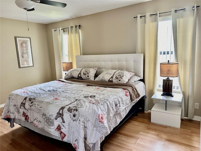 bedroom with light hardwood / wood-style floors and ceiling fan