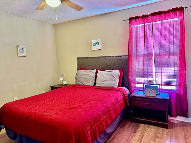 bedroom featuring a textured ceiling, hardwood / wood-style flooring, and ceiling fan