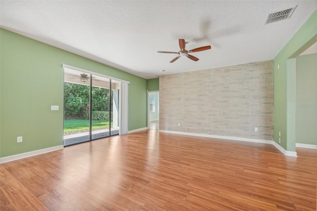 empty room featuring light hardwood / wood-style flooring and a textured ceiling