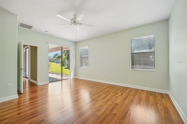 unfurnished room featuring wood-type flooring, a textured ceiling, and ceiling fan