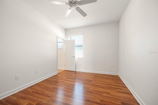 empty room featuring hardwood / wood-style floors, a textured ceiling, and ceiling fan