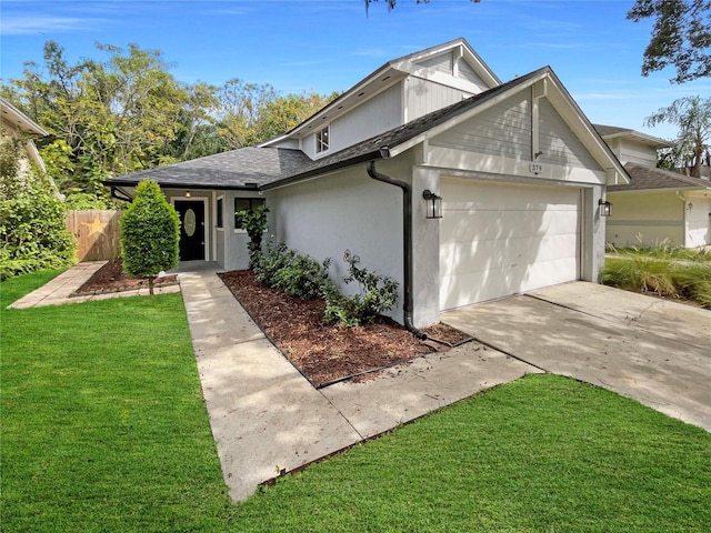 view of front of property featuring a garage and a front lawn