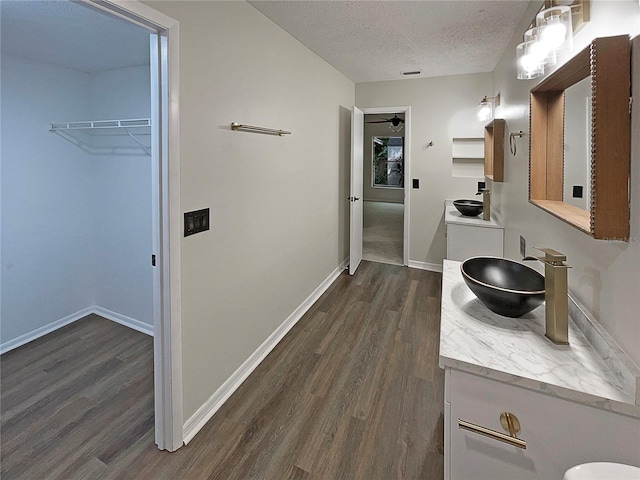 bathroom featuring wood-type flooring, a textured ceiling, and vanity