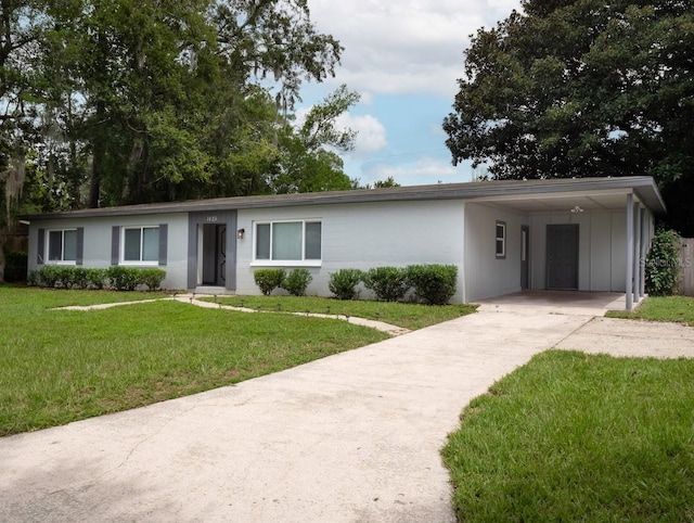 ranch-style house with a carport and a front yard