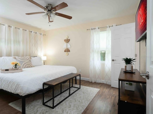 bedroom with ceiling fan and dark wood-type flooring