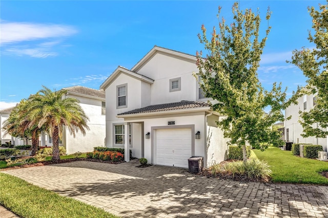 4782 Kings Castle Cir, Kissimmee, FL 34746 - view of front of house with stucco siding, decorative driveway, a garage, a front yard, and a tiled roof