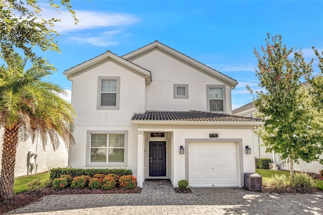 4782 Kings Castle Cir, Kissimmee, FL 34746 - view of front facade featuring stucco siding, decorative driveway, and a tiled roof