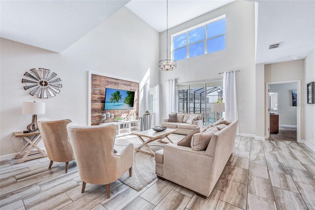 4782 Kings Castle Cir, Kissimmee, FL 34746 - living room featuring high vaulted ceiling, wood finish floors, a chandelier, and baseboards