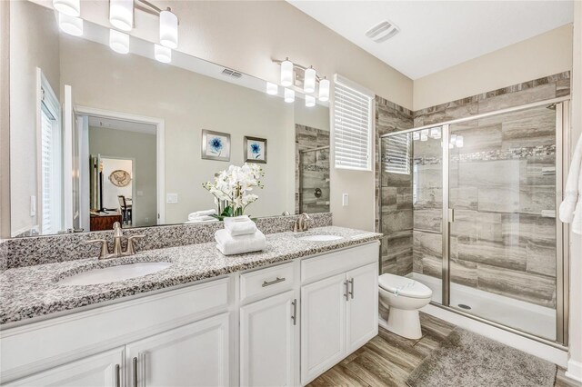 4782 Kings Castle Cir, Kissimmee, FL 34746 - full bath featuring toilet, double vanity, a stall shower, and wood finished floors