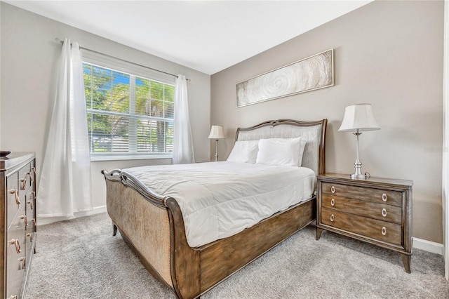 bedroom featuring light carpet