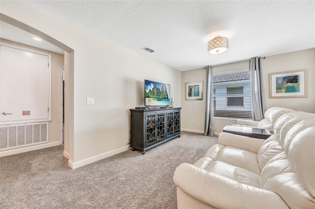 4782 Kings Castle Cir, Kissimmee, FL 34746 - living room with carpet flooring, baseboards, and a textured ceiling