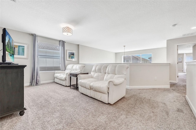 living room featuring a textured ceiling and light colored carpet