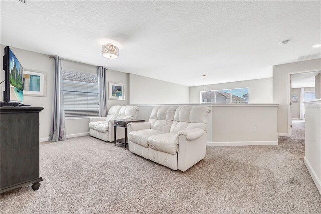 4782 Kings Castle Cir, Kissimmee, FL 34746 - living room featuring carpet floors, a textured ceiling, and baseboards