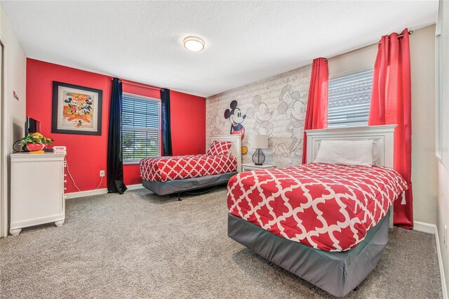 4782 Kings Castle Cir, Kissimmee, FL 34746 - carpeted bedroom featuring a textured ceiling, baseboards, and an accent wall