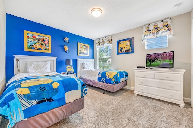 carpeted bedroom featuring a textured ceiling