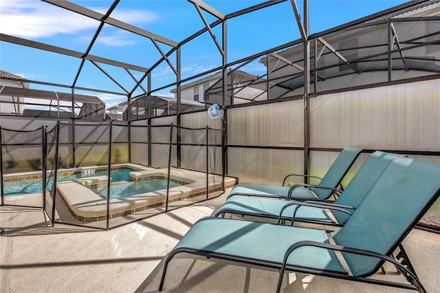 view of swimming pool with an in ground hot tub and a lanai