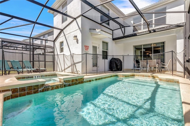 view of swimming pool featuring a patio, an in ground hot tub, and a lanai