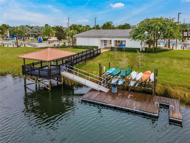 view of dock featuring a water view and a yard