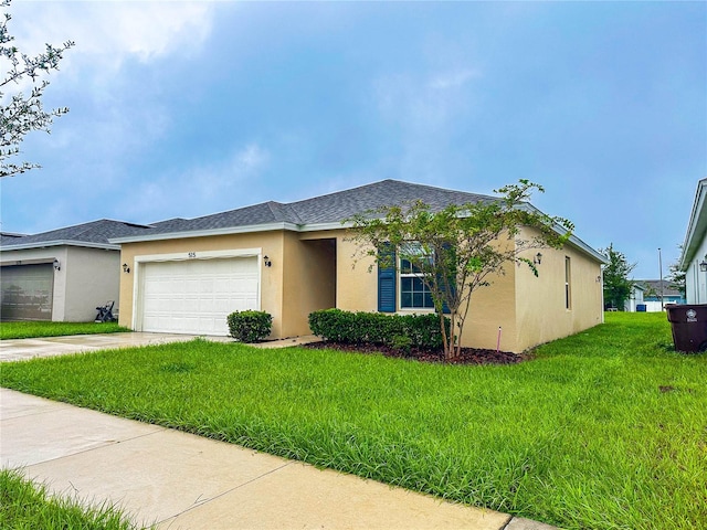 view of front of home with a front lawn and a garage