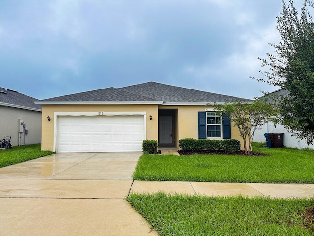 view of front of home with a front yard and a garage