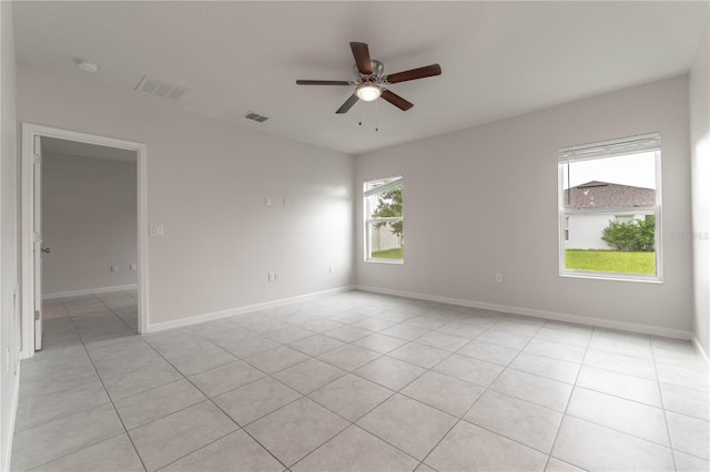 spare room featuring light tile patterned floors and ceiling fan