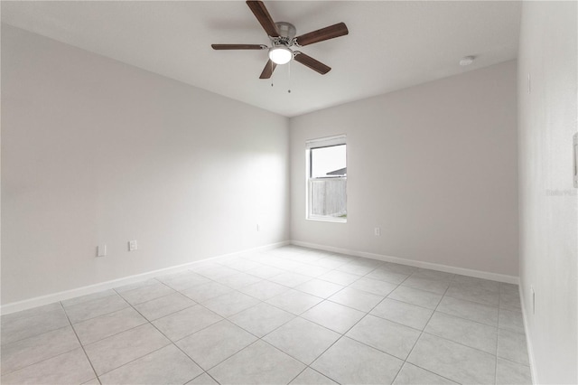 tiled spare room featuring ceiling fan