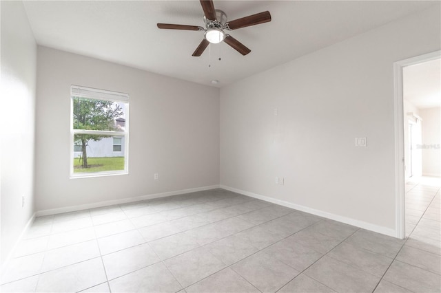 tiled empty room with ceiling fan