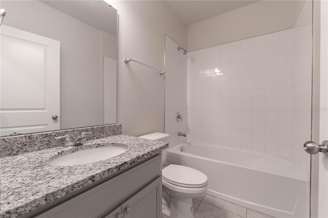 full bathroom with vanity, tiled shower / bath combo, toilet, and tile patterned floors