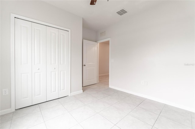 unfurnished bedroom with a closet, ceiling fan, and light tile patterned floors