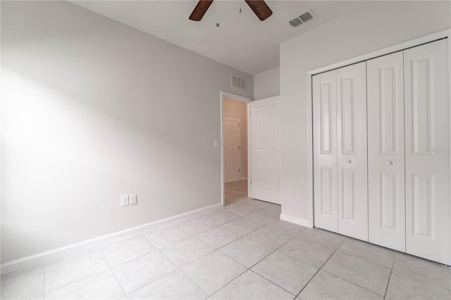 unfurnished bedroom featuring light tile patterned floors, a closet, and ceiling fan