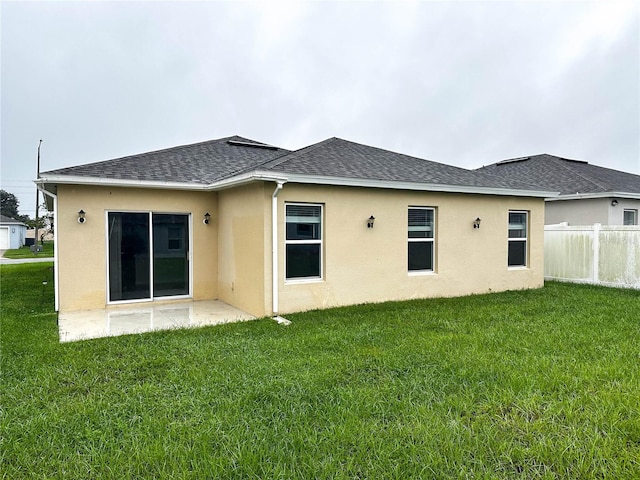 rear view of property with a patio area and a lawn