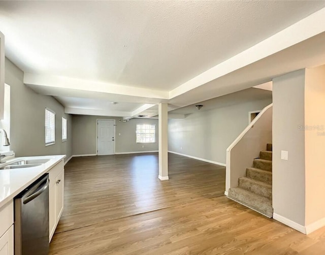 basement featuring sink and light hardwood / wood-style flooring