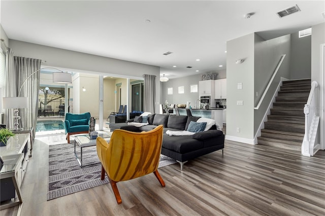 1407 Fairview Cir, Reunion, FL 34747 - living room with stairs, recessed lighting, visible vents, and wood finished floors