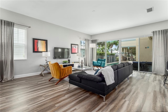 living room featuring plenty of natural light and light hardwood / wood-style floors