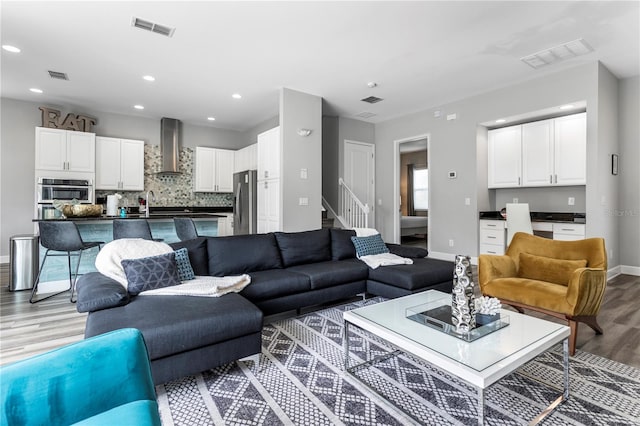 1407 Fairview Cir, Reunion, FL 34747 - living room featuring visible vents, light wood-style flooring, and baseboards