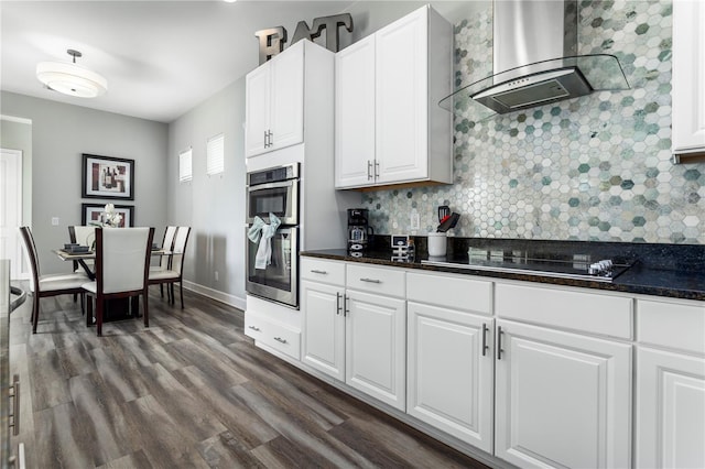 1407 Fairview Cir, Reunion, FL 34747 - kitchen featuring decorative backsplash, stainless steel double oven, range hood, dark wood-style floors, and black electric stovetop