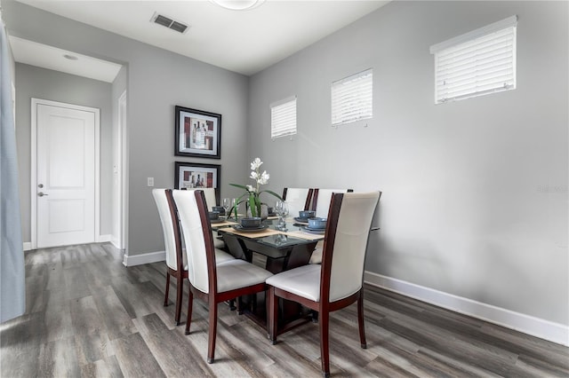 dining area with dark wood-type flooring