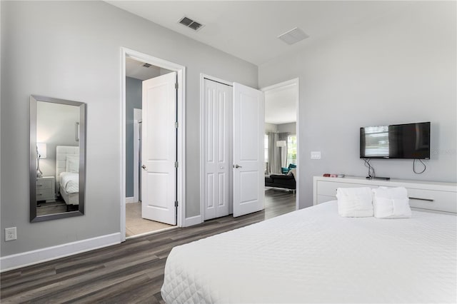 bedroom with dark hardwood / wood-style floors