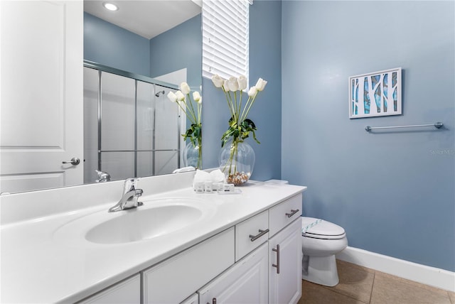 bathroom featuring tile patterned flooring, walk in shower, vanity, and toilet