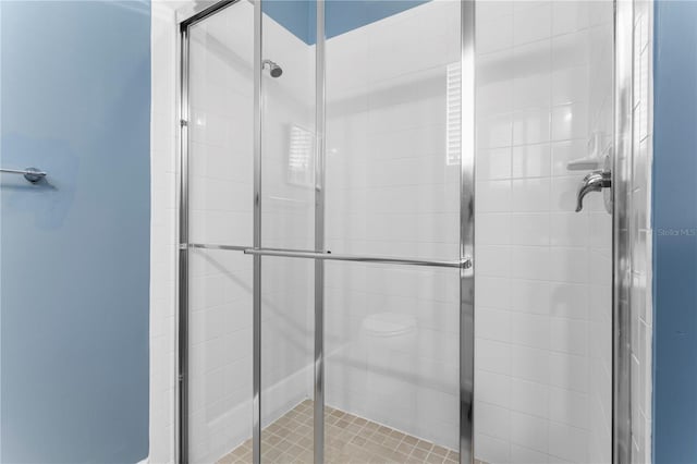 bathroom with a shower with shower door