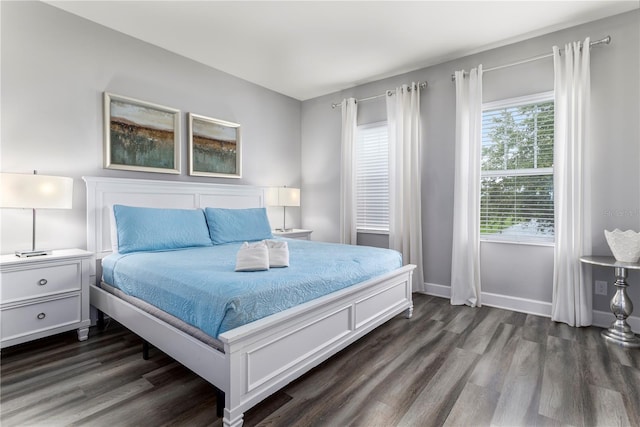 bedroom with dark wood-type flooring