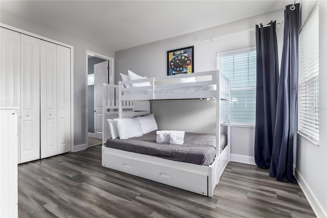 1407 Fairview Cir, Reunion, FL 34747 - bedroom with baseboards, a closet, and dark wood-style floors
