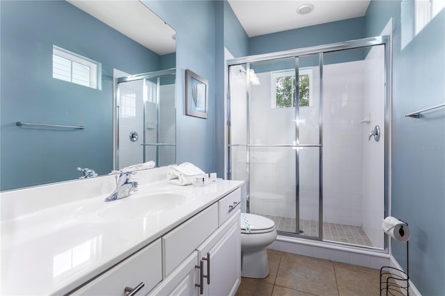 bathroom featuring an enclosed shower, vanity, tile patterned flooring, and toilet