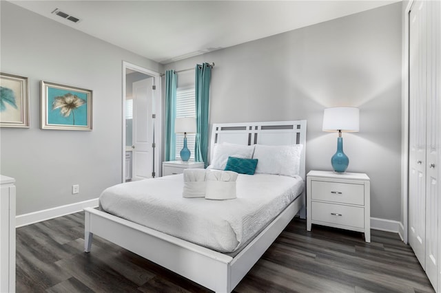 bedroom featuring a closet and dark hardwood / wood-style floors