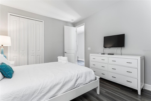 bedroom featuring a closet and dark hardwood / wood-style flooring